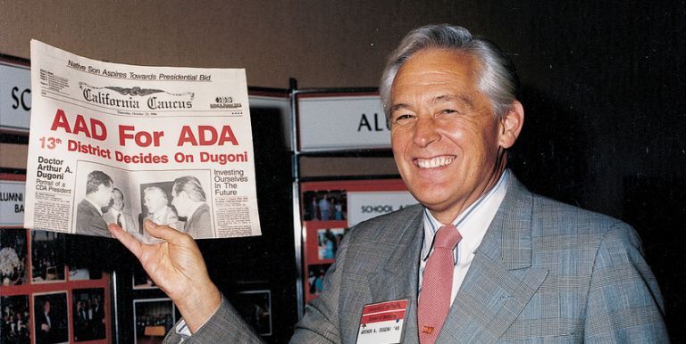 Arthur Dugoni holding newspaper