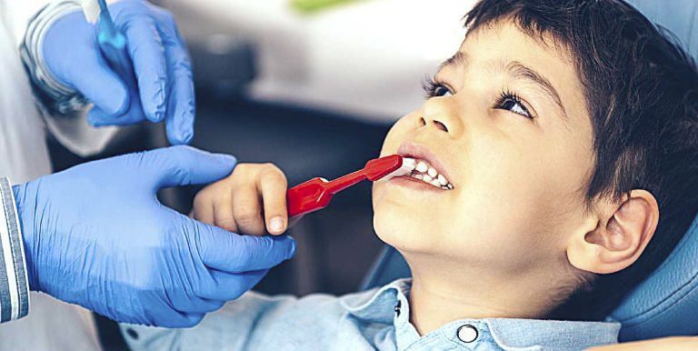 boy with red toothbrush