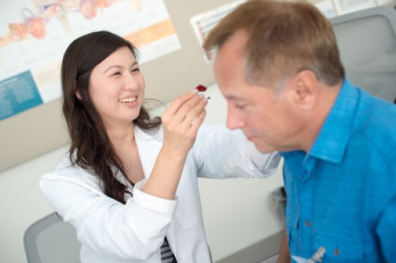 medical student performing ear exam