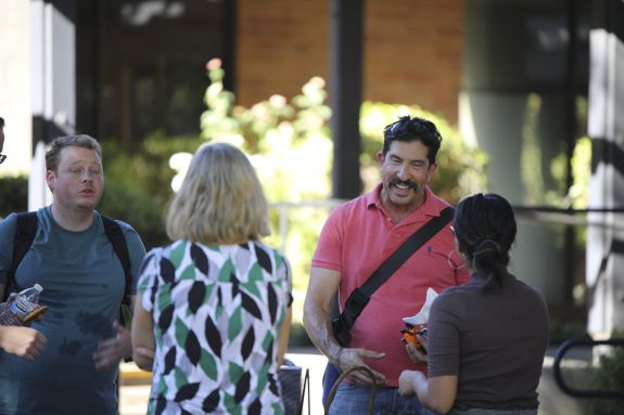 Two law students speak to law school staff.