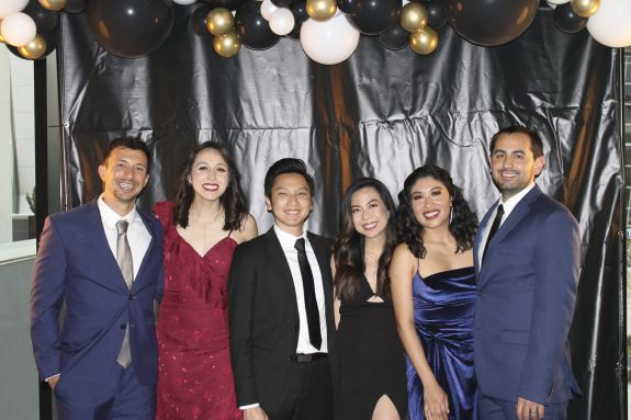 A group of six students dressed up at a ball