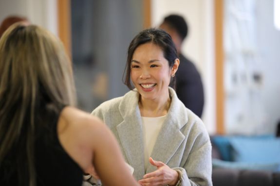 A law alumni speaks to a faculty member.