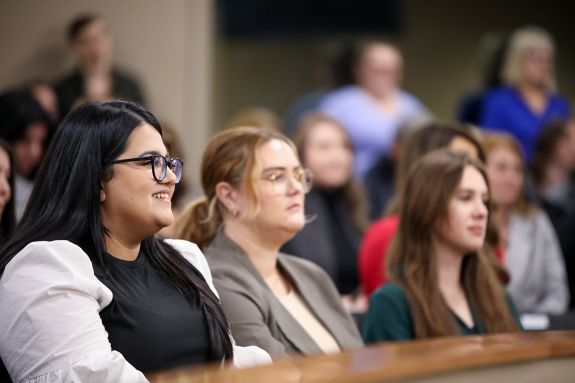 A law student sits in a courtroom.
