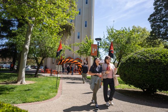 Student and parent walking down Knoles Lawn
