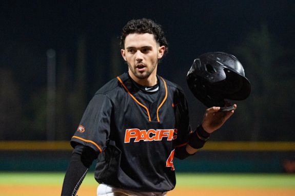 Pacific baseball player runs to first.