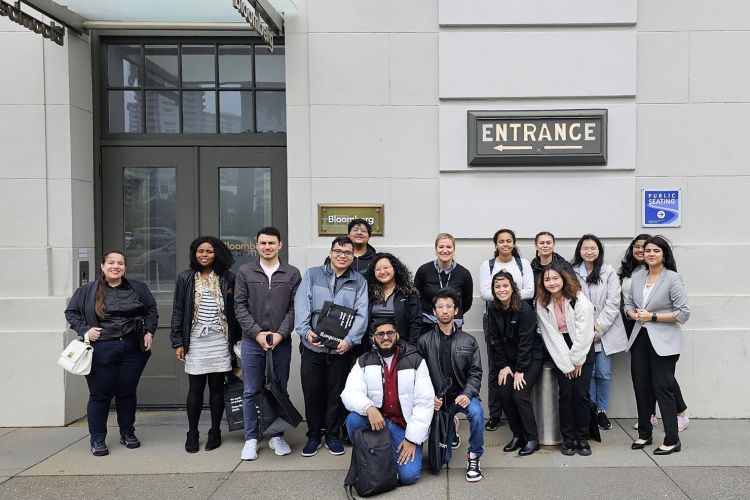 a group of students pose outside Bloomberg