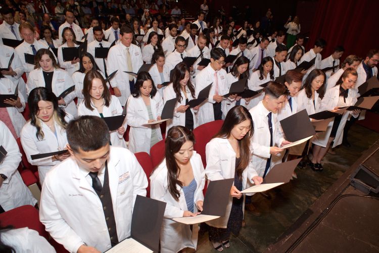 Dental students reading the oath of professionalism