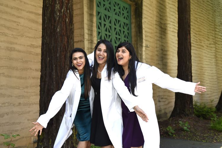 Dental students wearing their new white lab coats following the ceremony