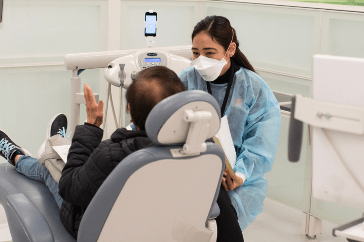 a dental student works with a patient