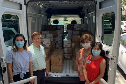 The Chan family next to van full of PPE