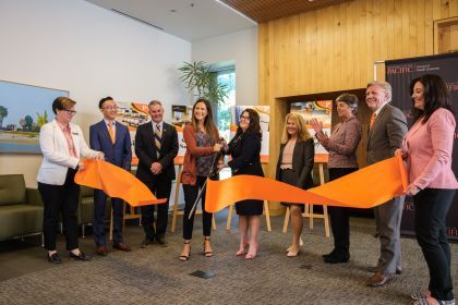 Students, faculty and university leaders hold a ribbon cutting ceremony