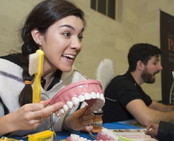 volunteer demonstrating toothbrushing