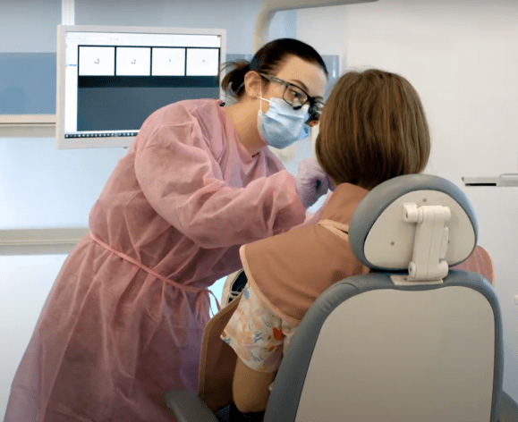 dental hygienist and patient in clinic